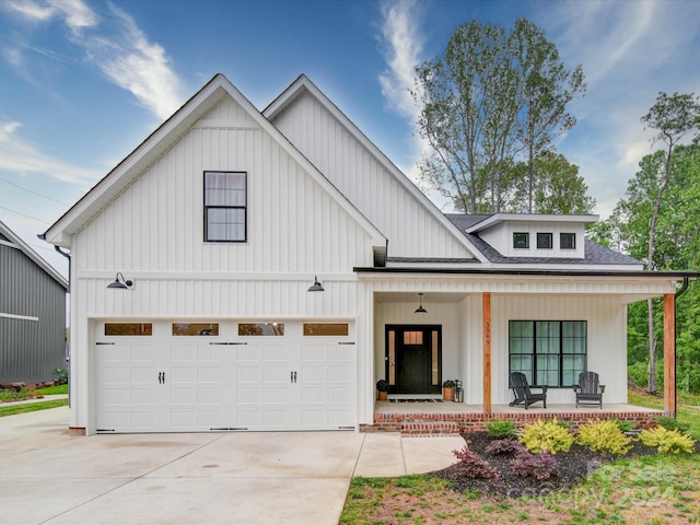 modern farmhouse with a porch and a garage