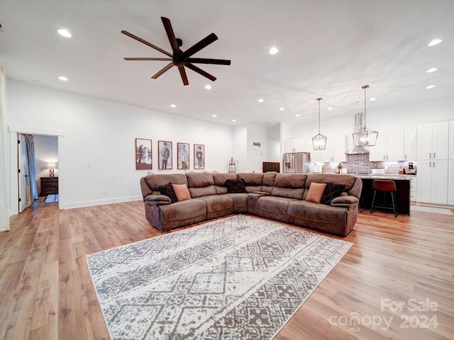 living room featuring ceiling fan and light wood-type flooring