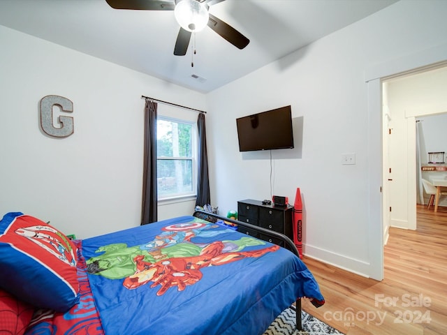 bedroom with wood-type flooring and ceiling fan