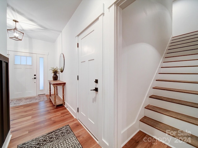 entrance foyer with a notable chandelier and light wood-type flooring