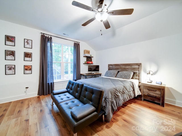 bedroom with ceiling fan, wood-type flooring, and lofted ceiling