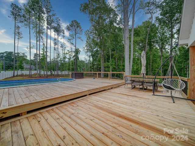 deck featuring a fenced in pool