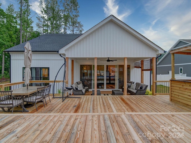 deck featuring ceiling fan and an outdoor living space