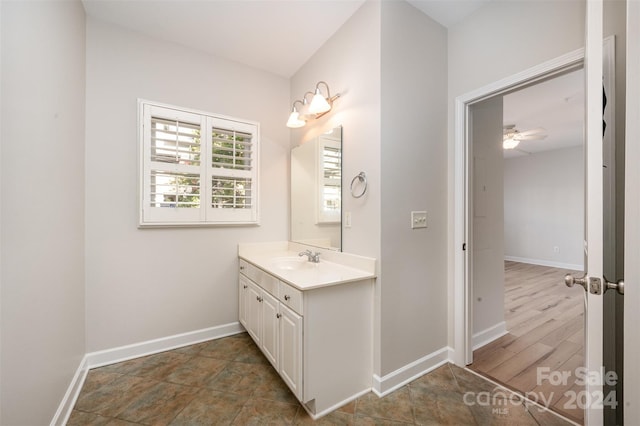 bathroom featuring ceiling fan, vanity, and wood-type flooring