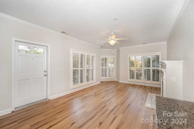 foyer entrance featuring ceiling fan, ornamental molding, and light hardwood / wood-style flooring