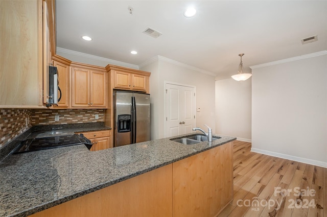 kitchen featuring decorative backsplash, stainless steel refrigerator with ice dispenser, sink, dark stone countertops, and light hardwood / wood-style floors