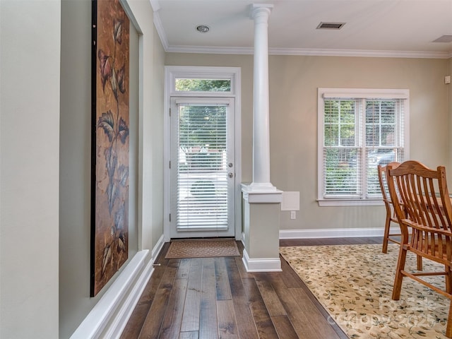 doorway to outside with crown molding, dark wood-type flooring, and ornate columns