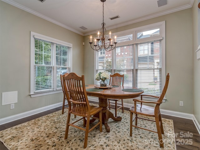 dining room featuring wood-type flooring, plenty of natural light, and ornamental molding