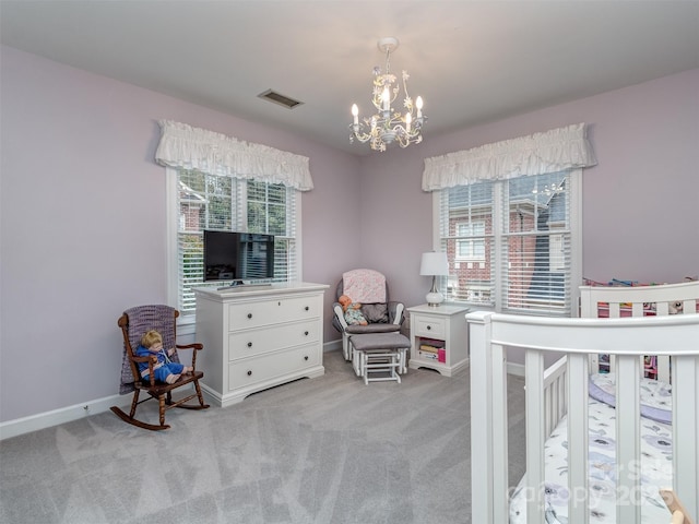 carpeted bedroom featuring a chandelier