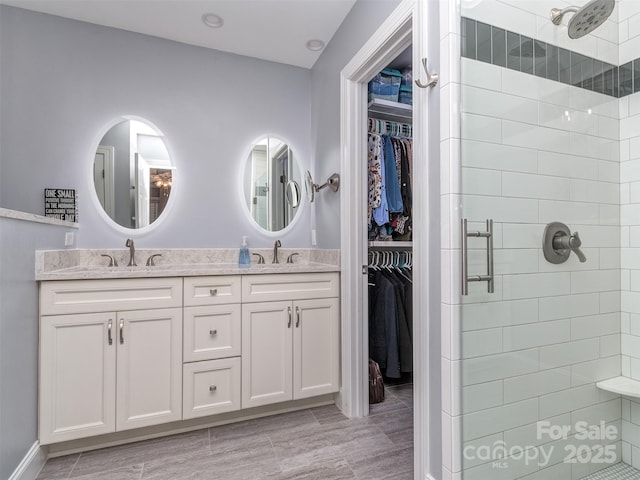 bathroom featuring vanity and a shower with shower door