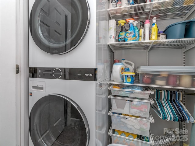 clothes washing area featuring stacked washer and dryer