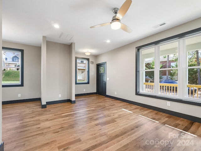 empty room featuring light wood-type flooring and ceiling fan