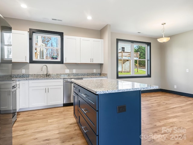 kitchen with white cabinets, light wood-type flooring, dishwasher, and sink