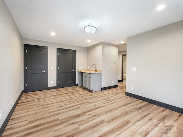 interior space with light hardwood / wood-style floors and sink