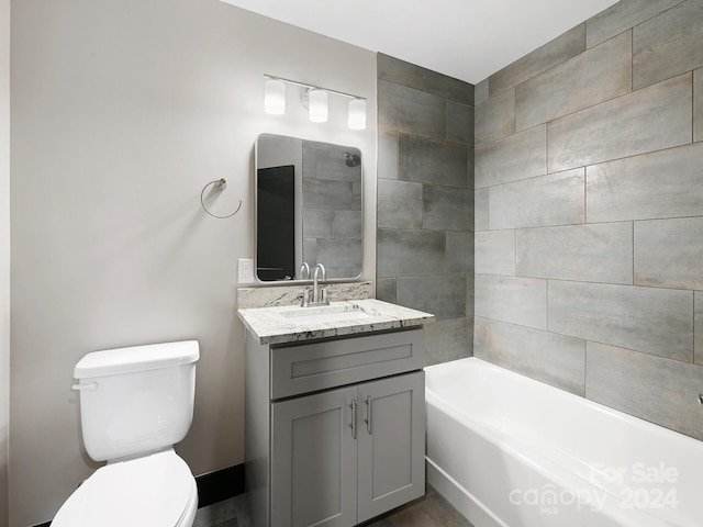 full bathroom featuring vanity, toilet, and tiled shower / bath combo