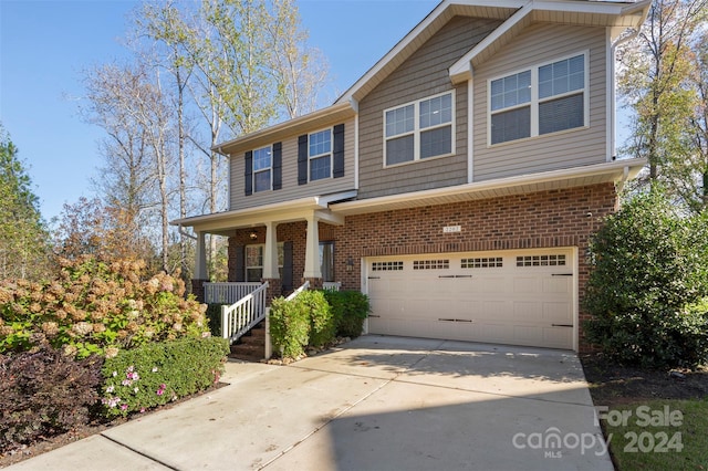 view of front of house with a porch and a garage