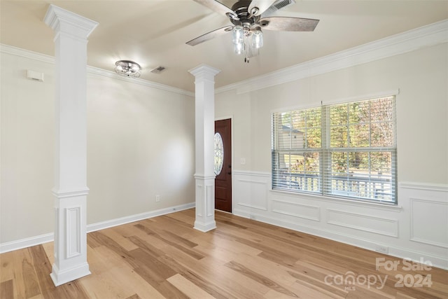 interior space with light hardwood / wood-style floors, ceiling fan, ornamental molding, and decorative columns