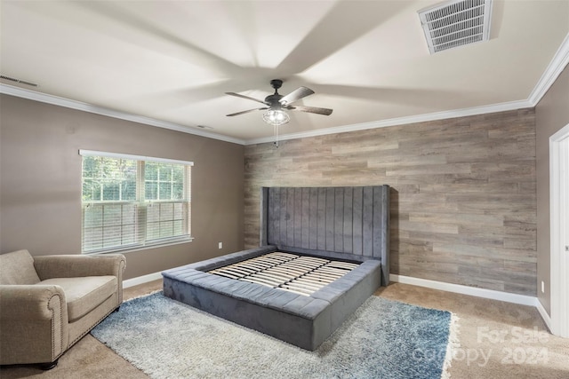 bedroom featuring carpet flooring, ceiling fan, ornamental molding, and wooden walls