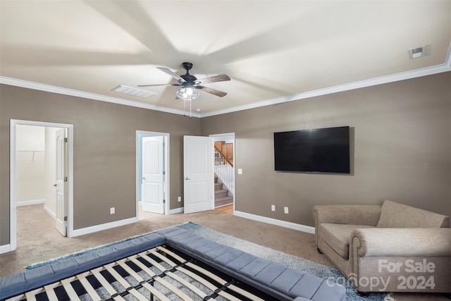 sitting room featuring ceiling fan, light carpet, and ornamental molding