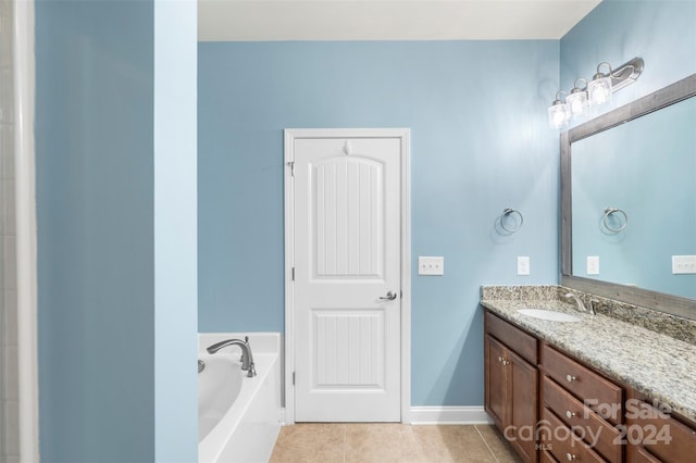 bathroom with tile patterned flooring, vanity, and a bathtub