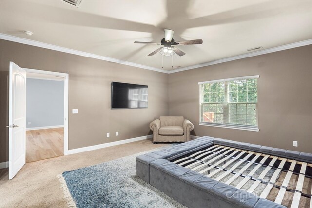 carpeted bedroom featuring ceiling fan and ornamental molding