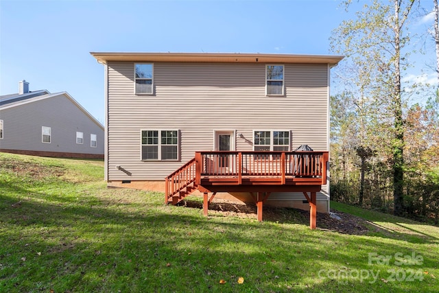 back of property featuring a deck and a lawn