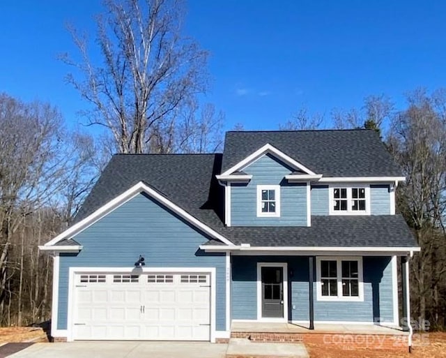 view of front of property with a garage and covered porch