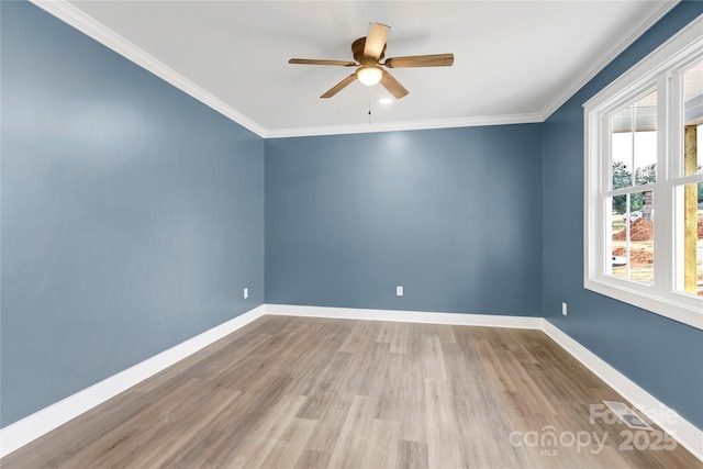 spare room with ornamental molding, ceiling fan, and light hardwood / wood-style floors