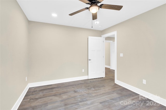 unfurnished room featuring ceiling fan, baseboards, and wood finished floors