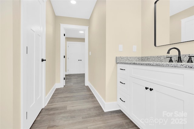 bathroom with wood-type flooring and vanity