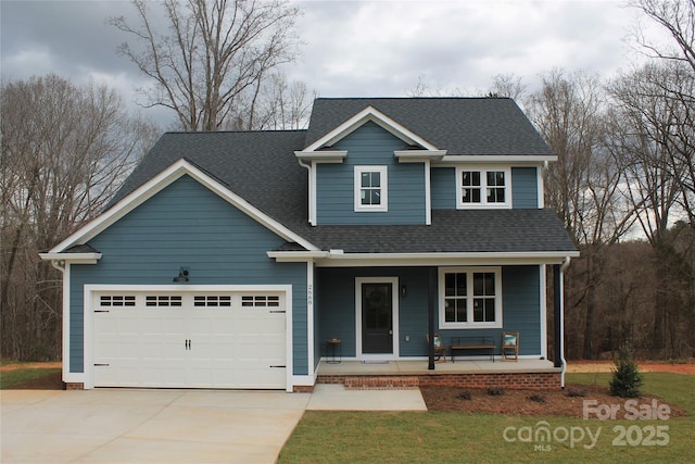 traditional-style house featuring a garage, covered porch, driveway, and roof with shingles