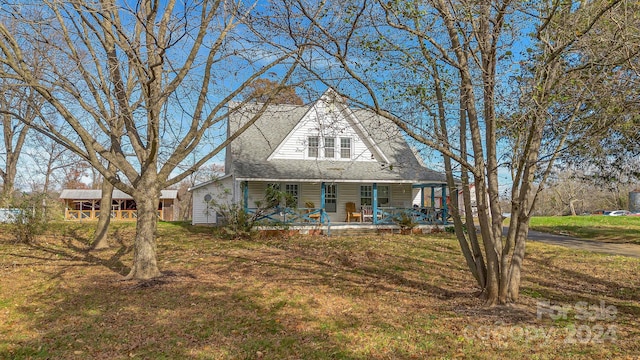 view of front of house with covered porch and a front yard