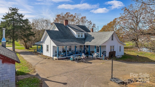 rear view of house with covered porch