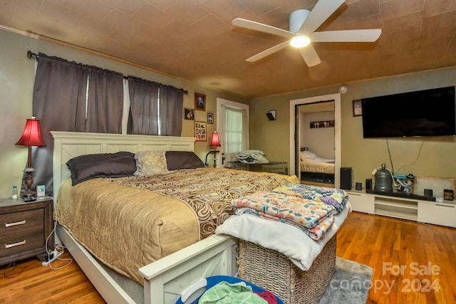 bedroom with ceiling fan and light hardwood / wood-style flooring