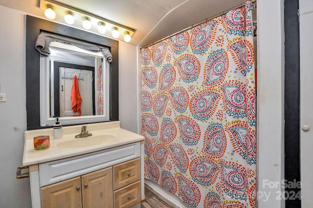 bathroom with a shower with shower curtain, wood-type flooring, and vanity