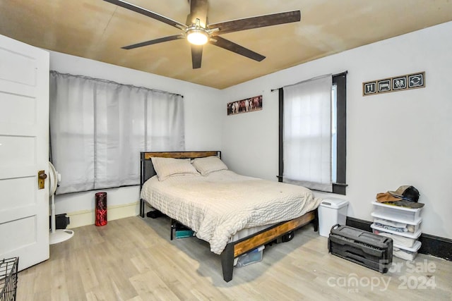 bedroom with ceiling fan and light wood-type flooring