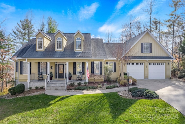 view of front facade featuring a front yard, a porch, and a garage