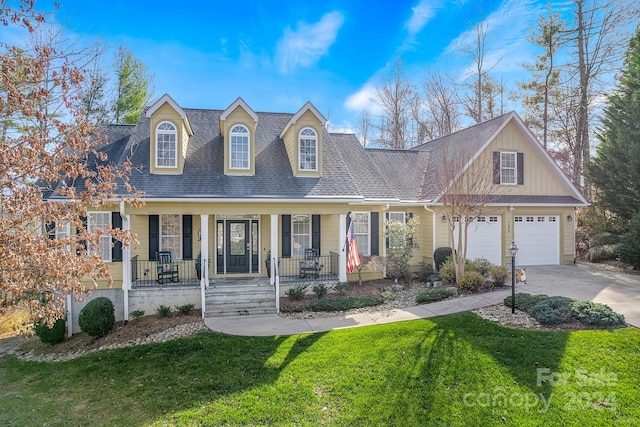 view of front facade with a porch, a garage, and a front lawn