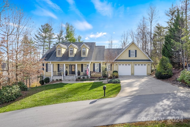 view of front of house featuring covered porch, a garage, and a front yard