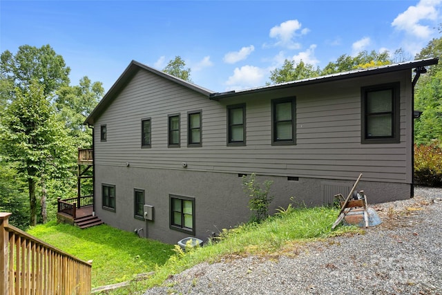 view of home's exterior featuring a wooden deck