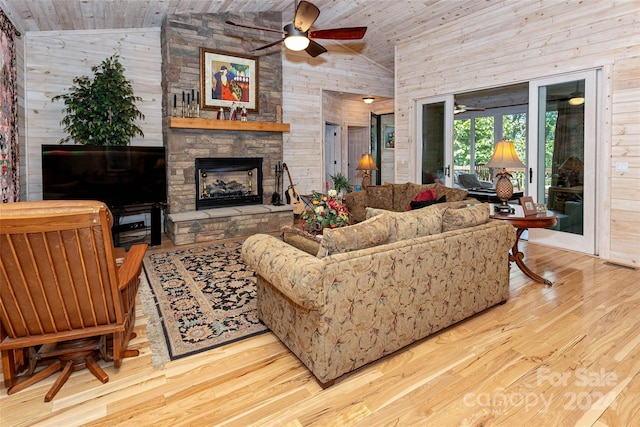 living room featuring high vaulted ceiling, wooden ceiling, and wood walls