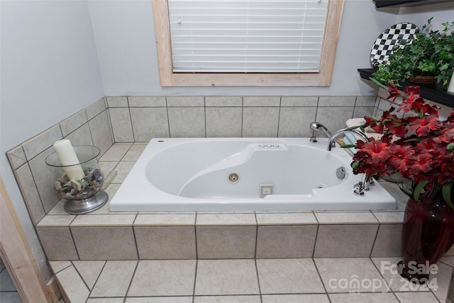 bathroom with tile patterned flooring and a relaxing tiled tub