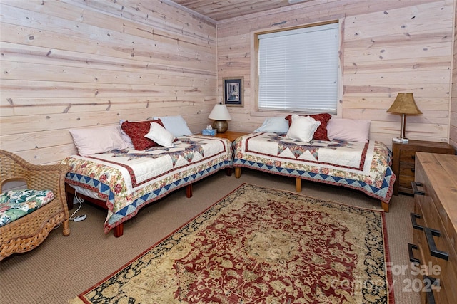 bedroom featuring carpet and wood walls