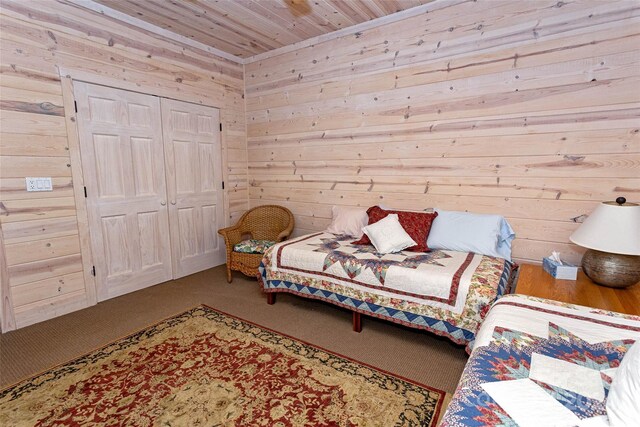 bedroom featuring carpet flooring, wood walls, wood ceiling, and a closet