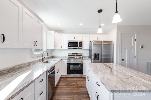 kitchen featuring white cabinetry, sink, stainless steel appliances, dark hardwood / wood-style flooring, and pendant lighting