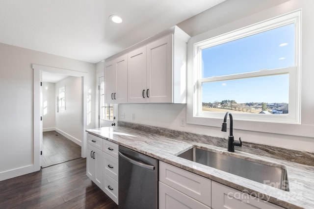 kitchen featuring light stone countertops, white cabinetry, dishwasher, and dark wood-type flooring