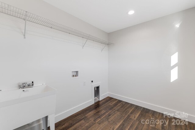 washroom with hookup for an electric dryer, washer hookup, dark hardwood / wood-style floors, and sink