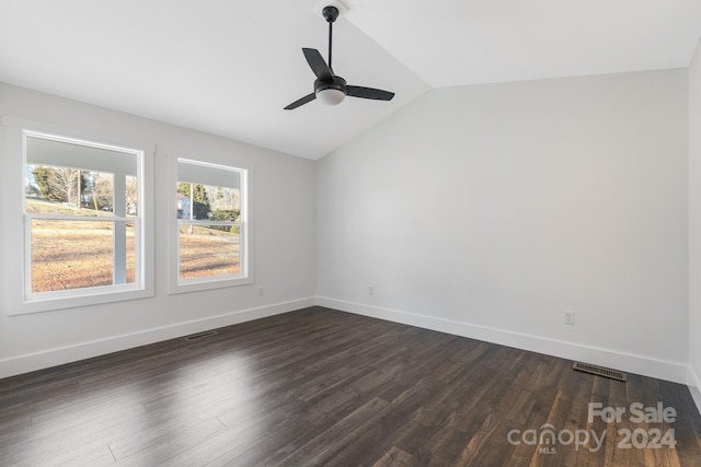 empty room with ceiling fan, dark wood-type flooring, and vaulted ceiling