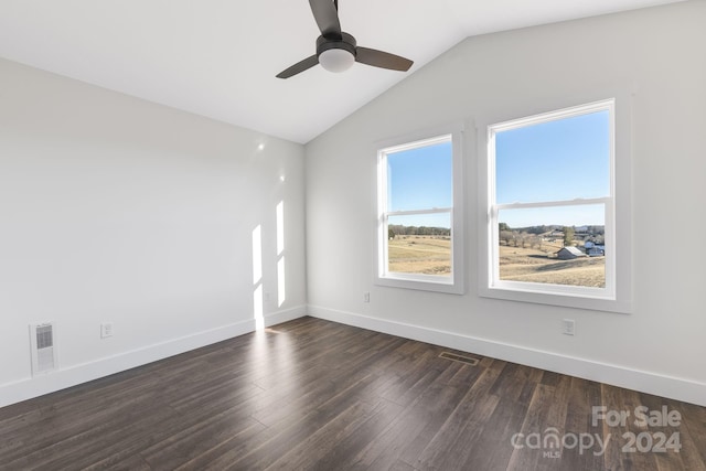 empty room with ceiling fan, dark hardwood / wood-style flooring, and vaulted ceiling