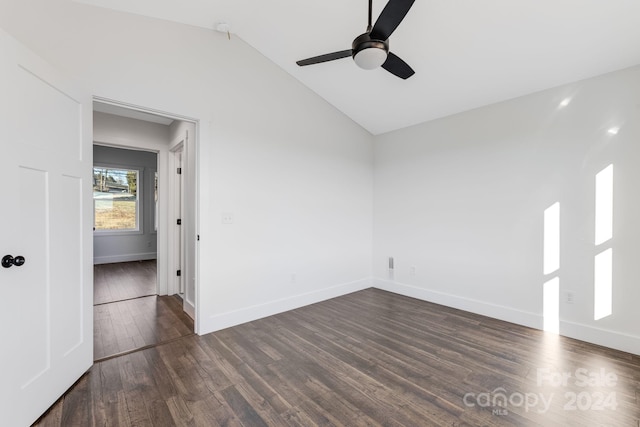 unfurnished room with dark hardwood / wood-style flooring, vaulted ceiling, and ceiling fan